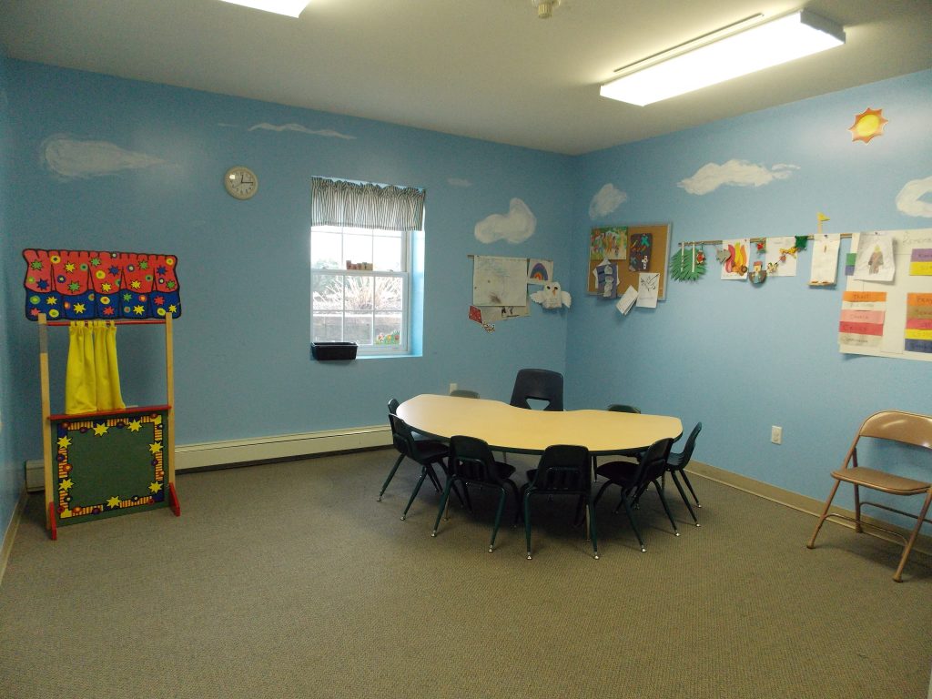 Kid's chairs around a desk in a classroom